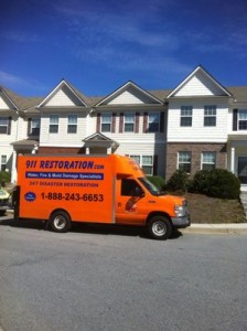 Water Damage Restoration Truck At Townhouse