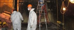 Water Damage Technician Working In Flooded Garage